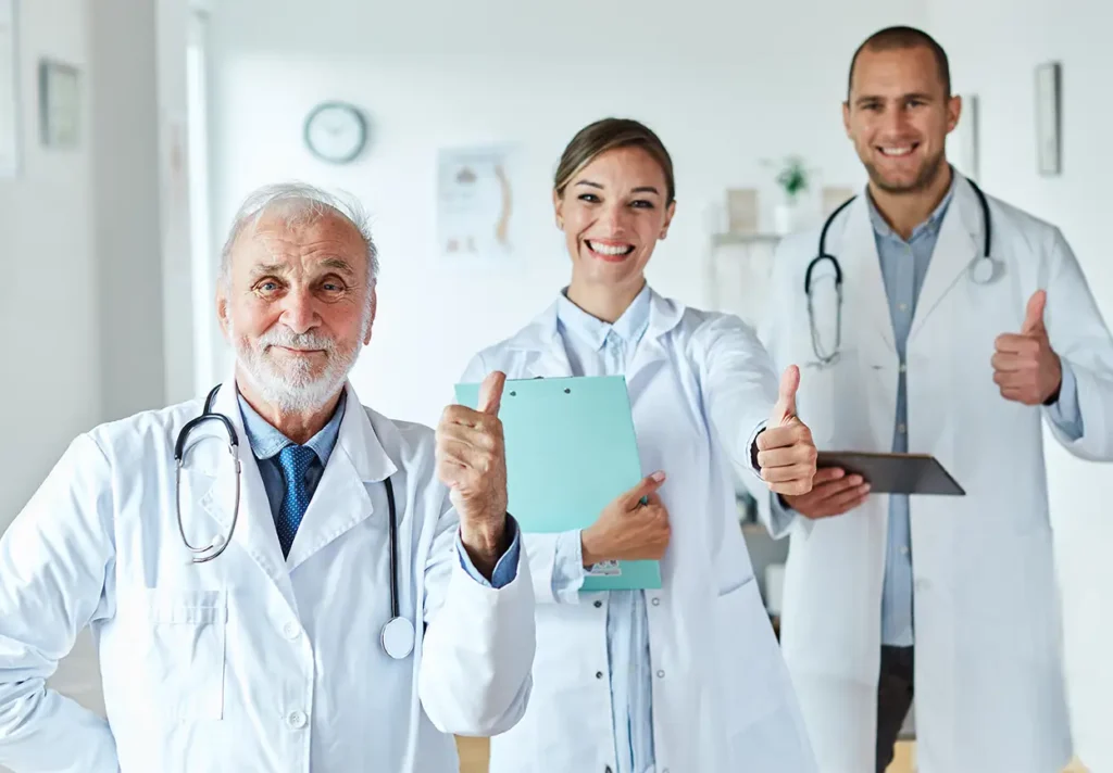 three doctors giving thumbs up