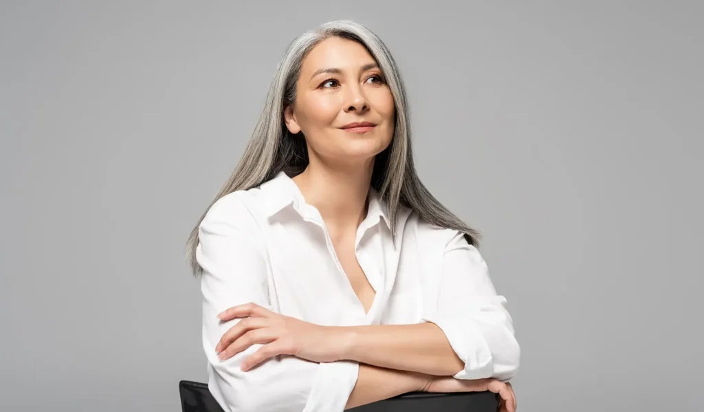 smiling woman with gray hair sitting