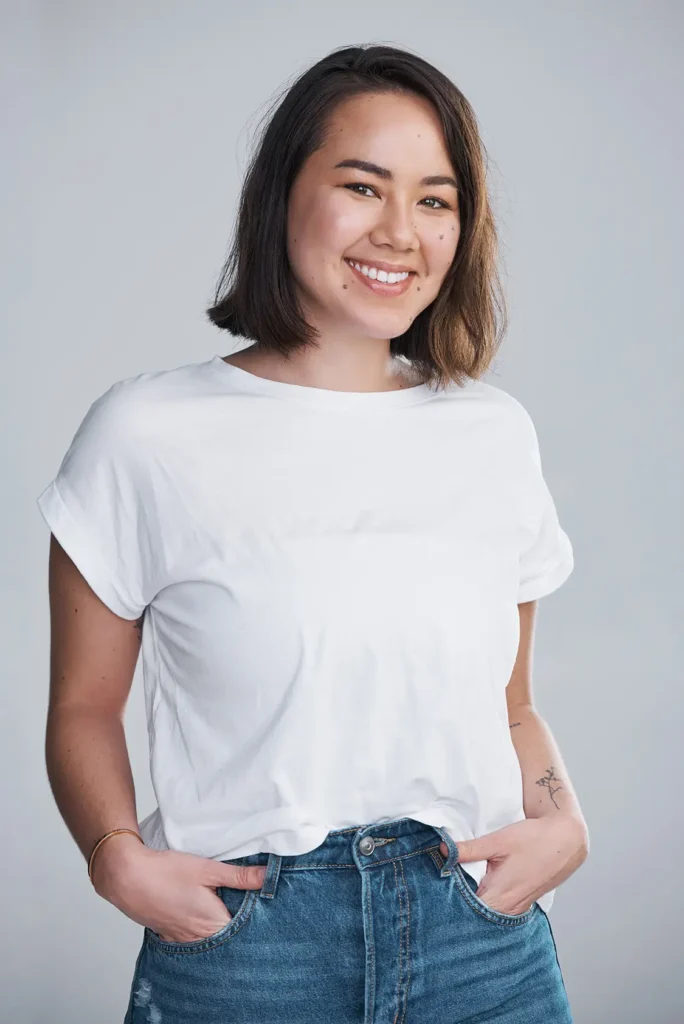 smiling woman in white shirt and jeans